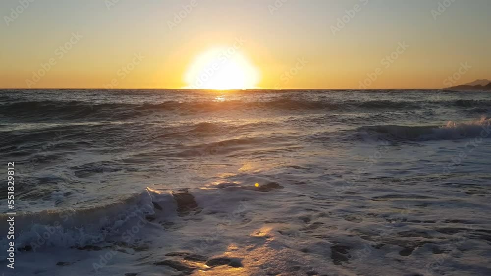 Sunset on the horizon over the Mediterranean Sea viewed from a sandy beach Sunset on the horizon over the Mediterranean Sea viewed from a sandy beach