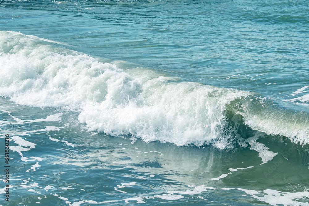 Background with sea waves. White foam on the surface of the water.