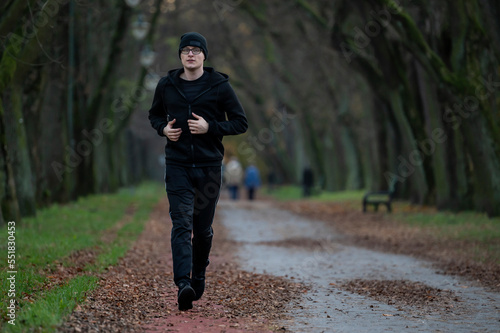 Runner in autumn park.