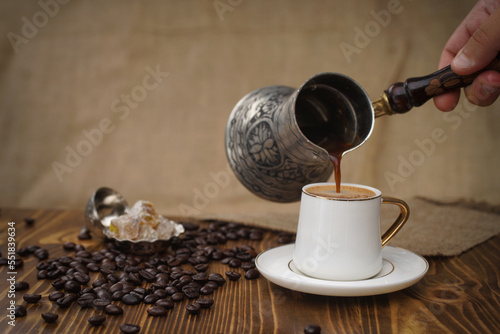 Bild auf Leinwand Hot Turkish coffee on wooden floor, Turkish delight next to it.