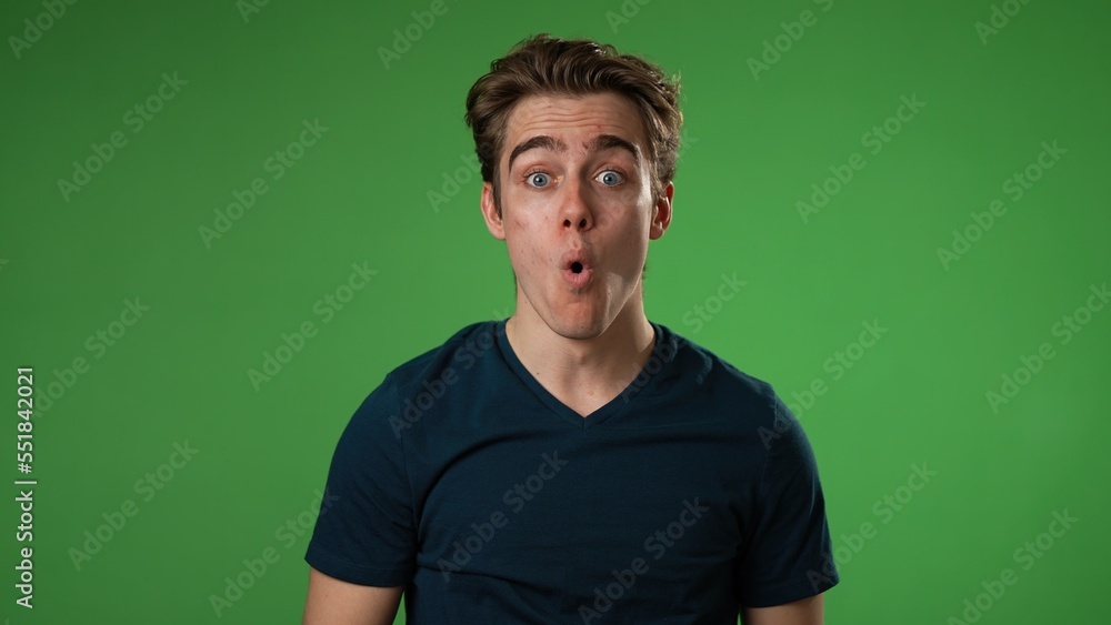 Portrait of amazed young man 20s shocked, saying WOW then give thumbs up. Handsome guy surprised isolated on solid green screen background Portrait of amazed young man 20s shocked, saying WOW then give thumbs up. Handsome guy surprised isolated on solid green screen background