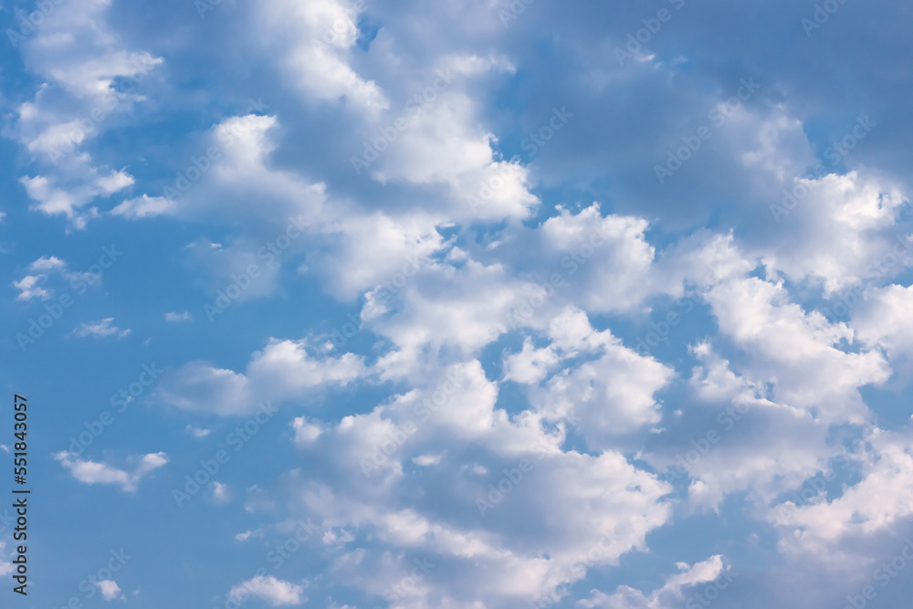 Fototapeta premium Clouds in the blue sky. Natural sky background texture, beautiful color. Peaceful blue sky with light clouds. The free form beauty of clouds and sky is perfect for background, backdrop and wallpaper.