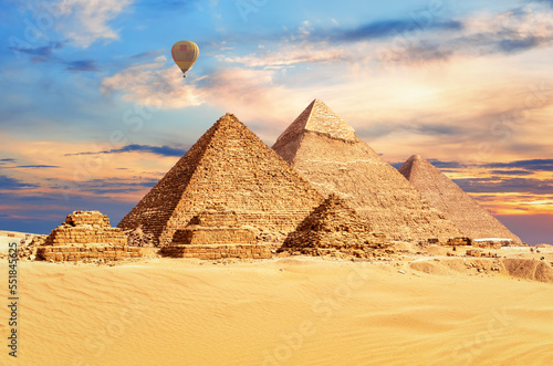 The Great Pyramids of Egypt under a colorful desert sky, Giza