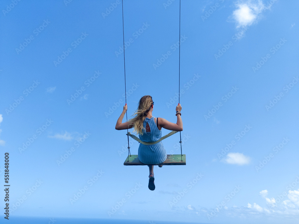 Women swinging in the sky 