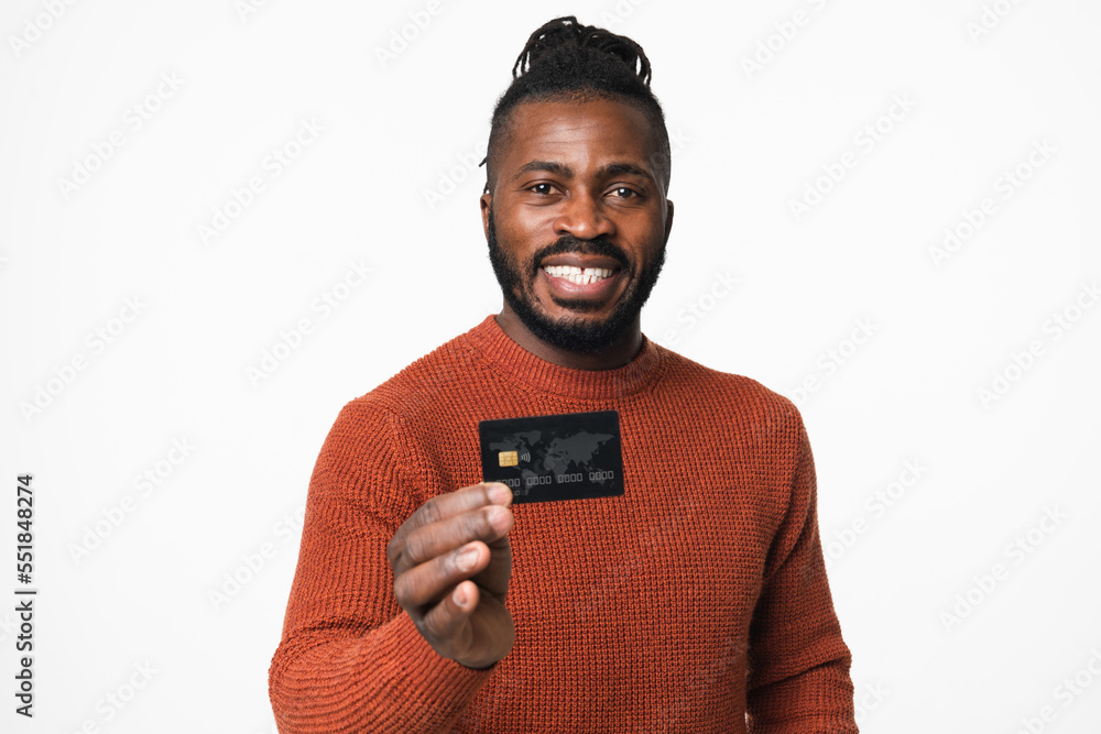 Smiling happy african-american young man holding credit card showing in ...