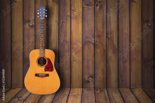 Acoustic Guitar in wooden vintage room.