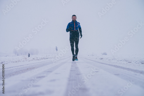 Man running in winter on the snow