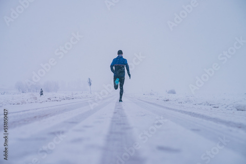 Man running in winter on the snow
