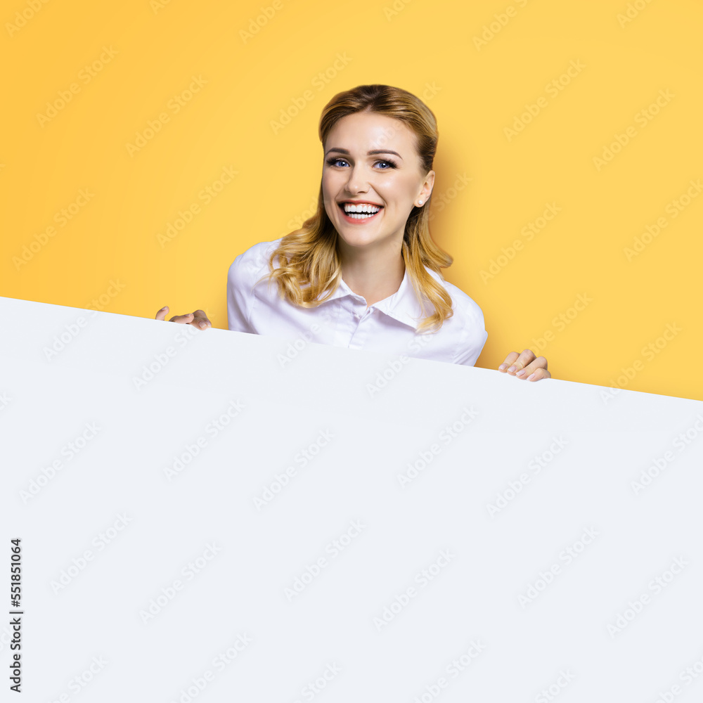 Very happy excited, laughing business woman in white confident clothing standing behind empty banner signboard with copy space area. Success and ad concept. Yellow background. Square image. Very happy excited, laughing business woman in white confident clothing standing behind empty banner signboard with copy space area. Success and ad concept. Yellow background. Square image.