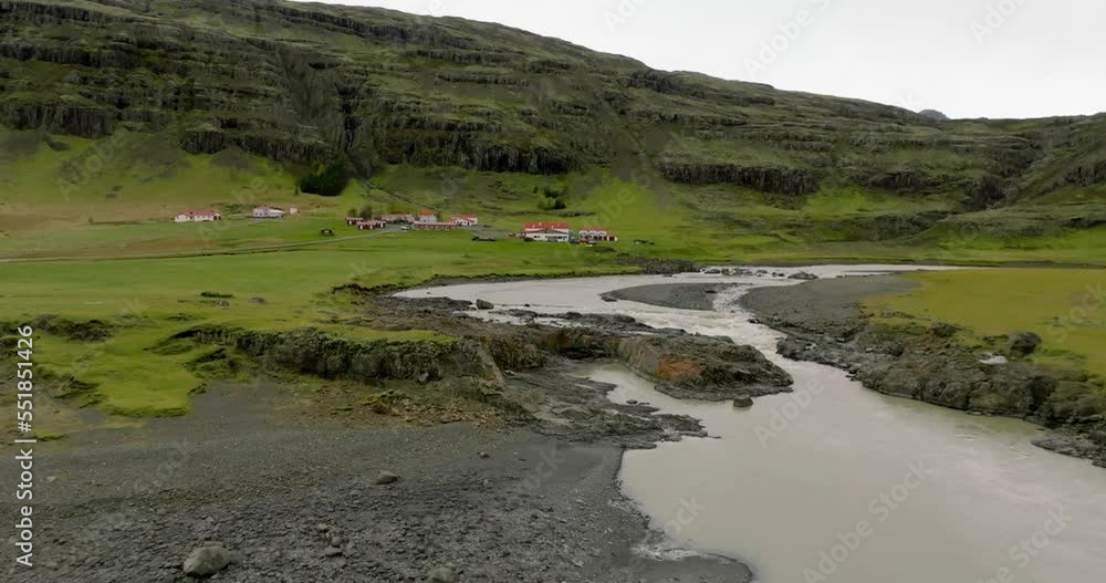 aerial view of kolgrima river and small village with houses under mountain aerial view of kolgrima river and small village with houses under mountain