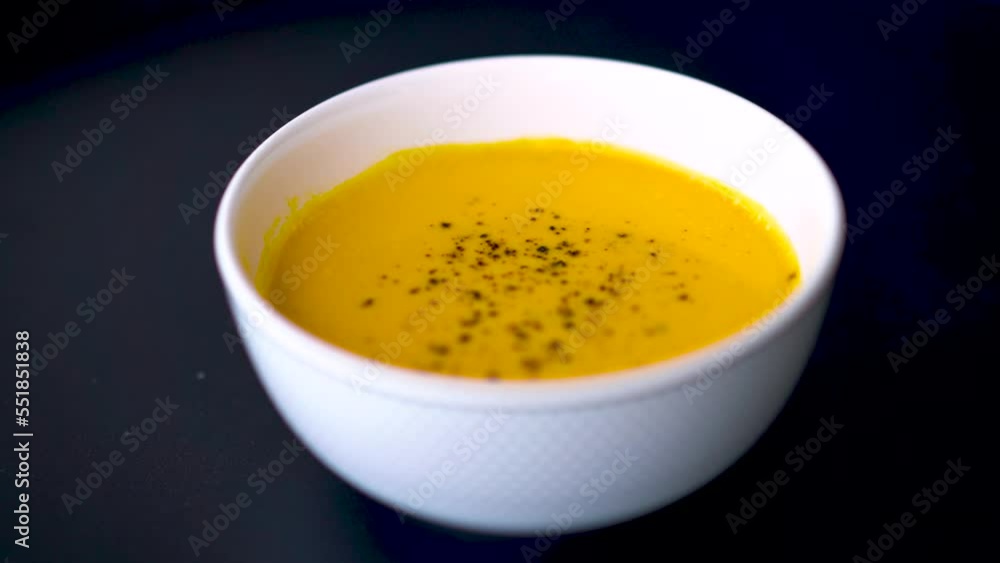 Pumpkin soup shot on a black background Pumpkin soup shot on a black background