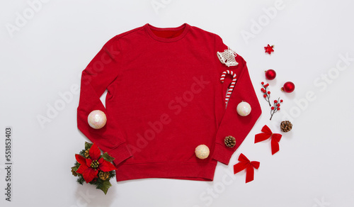 Close up banner red blank template sweatshirt with copy space and Christmas Holiday concept. Top view mockup hoodie and red holidays decorations on white background. Happy New Year accessories. Xmas photo