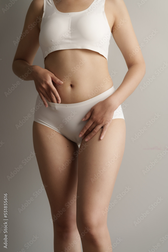 Close up asian woman cropped shot with white panties on grey background,  vagina healthy concept. Stock Photo