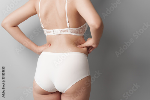 Close-up beauty asian woman in white bra and panties isolated over white background.