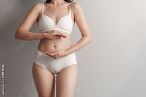 Close-up beauty asian woman in white bra and panties isolated over white background.