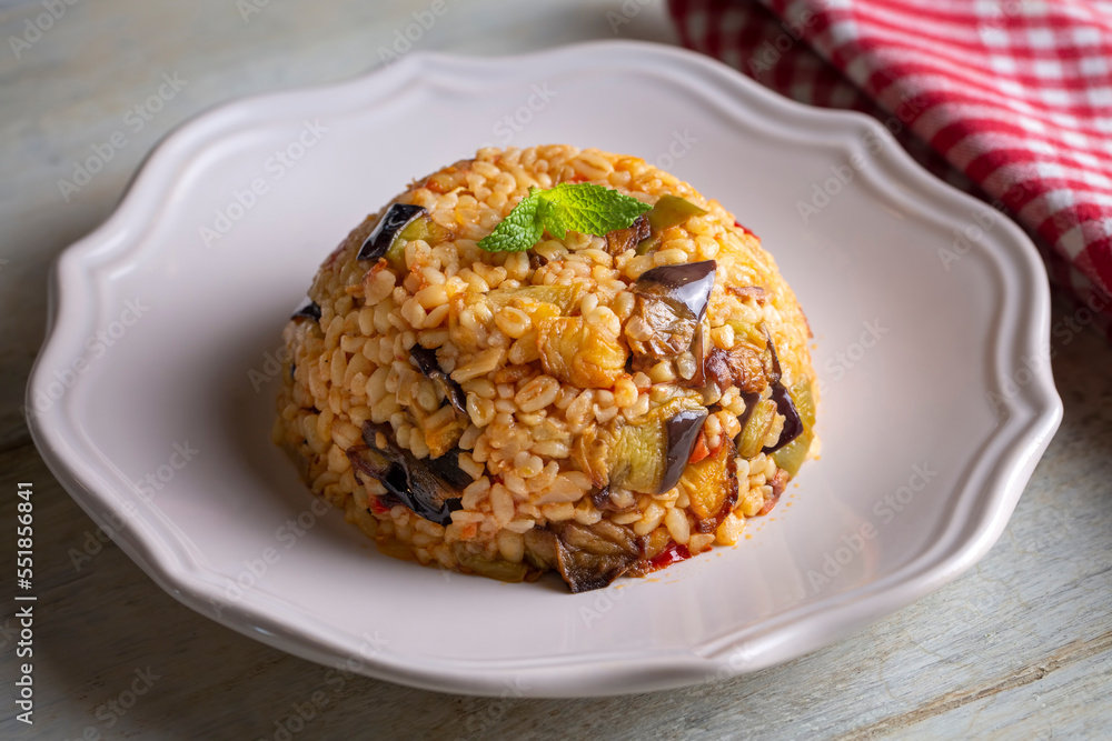 Traditional delicious Turkish food; Bulgur pilaf with eggplant and vegetables. (Turkish name; Patlicanli bulgur pilavi) Traditional delicious Turkish food; Bulgur pilaf with eggplant and vegetables. (Turkish name; Patlicanli bulgur pilavi)