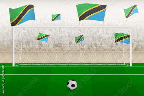 Tanzania football team fans with flags of Tanzania cheering on stadium, penalty kick concept in a soccer match.