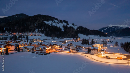 Winter landscape, Dobbiaco Toblach, Bolzano, Italy. Aerial drone shot in january, Aerial view of beautiful alpin mountain town, christmas time , city with lights