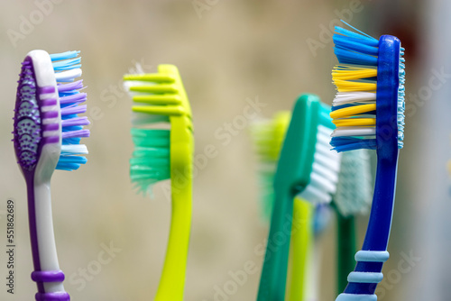 Toothbrushes in glass on table. Selective focus.
