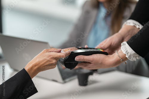 Close up on contactless paying terminal for credit cards  contactless paying Woman hand