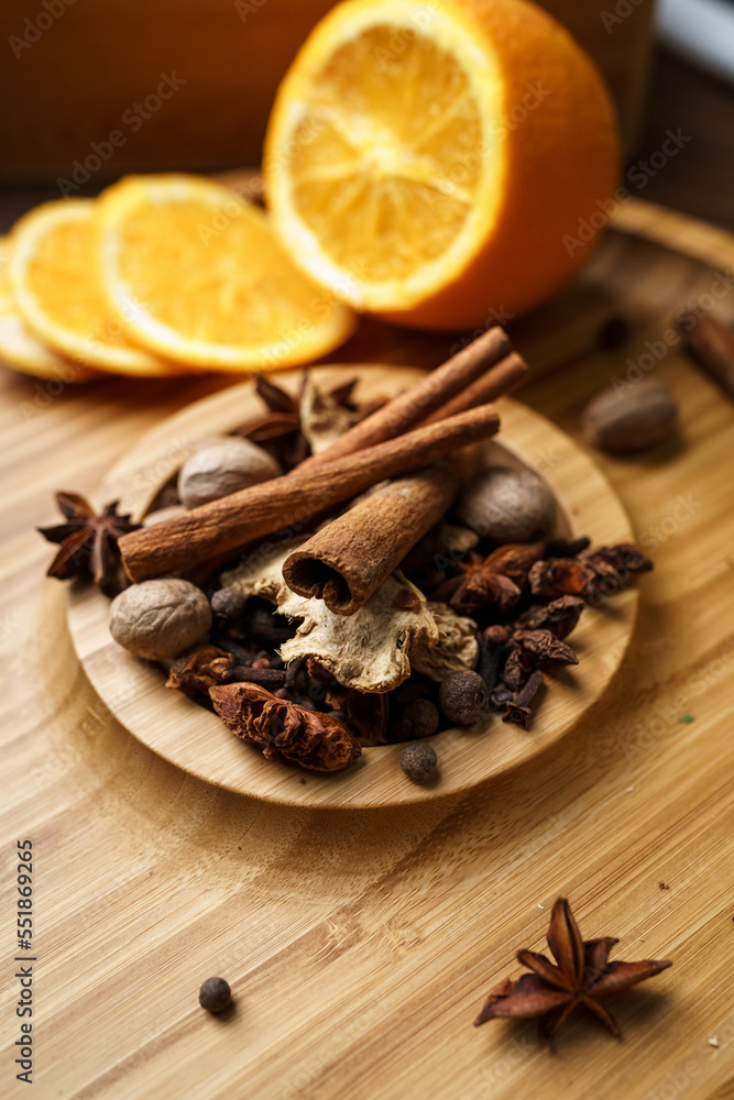 Spices for making mulled wine in a wooden bowl Spices for making mulled wine in a wooden bowl