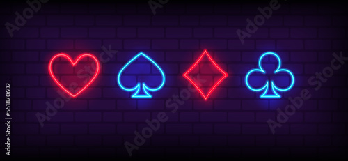 Neon signs set of Suits of playing cards. Card suits, Poker, Blackjack neon icons. Glowing casino signboard. Aces Playing Cards symbols with Glowing Neon Lights on brick wall background