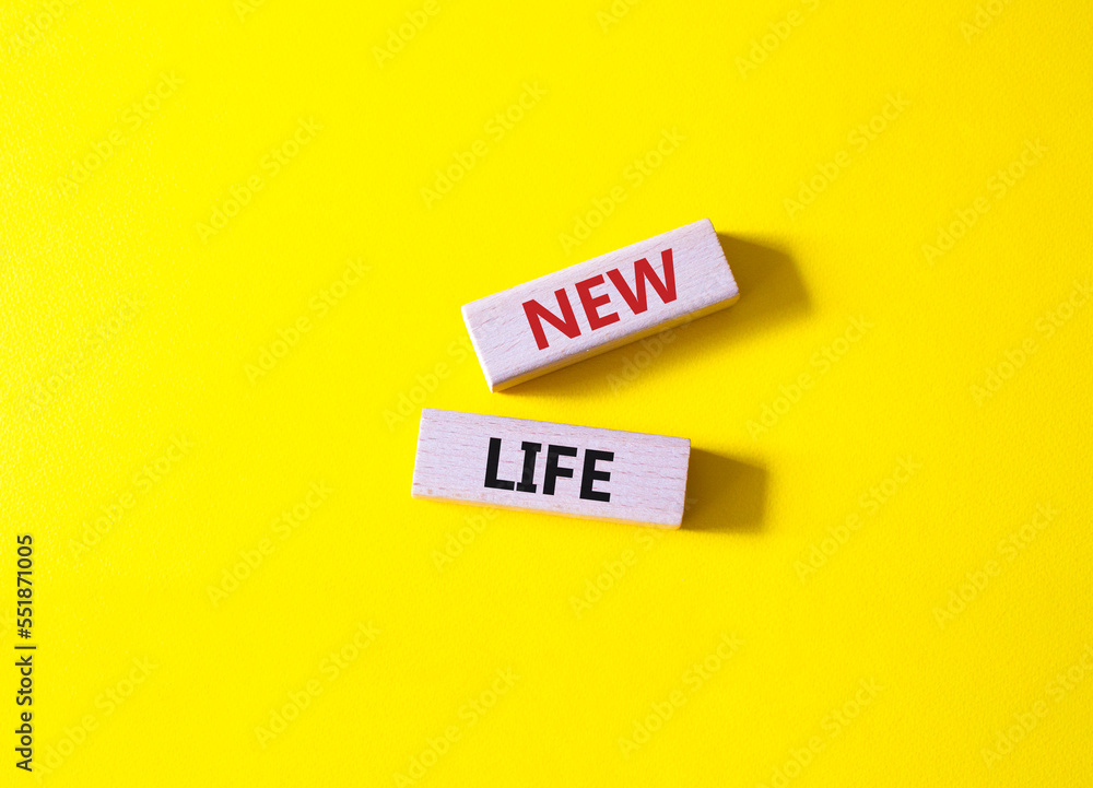 New life symbol. Wooden blocks with words New life. Beautiful yellow background. Business and New life concept. Copy space. New life symbol. Wooden blocks with words New life. Beautiful yellow background. Business and New life concept. Copy space.