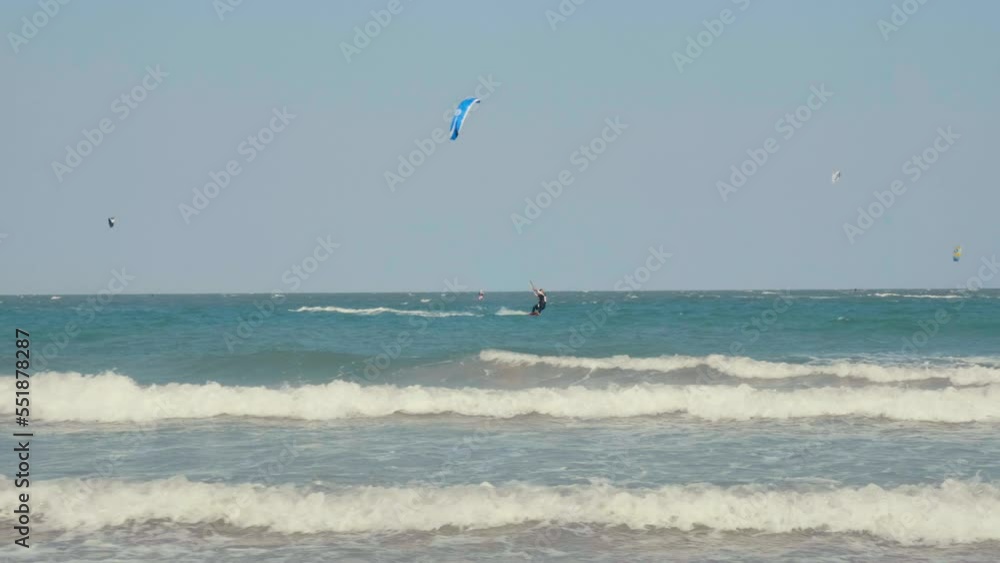 Kite surfing or windsurfing on blue sea water Kite surfing or windsurfing on blue sea water