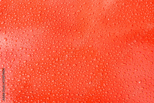 background of water drops on a red plane