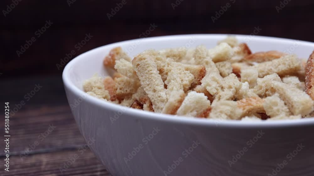 White Bread Crackers. Bread Crispy Crackers From White Bread In A White Bowl. Breadcrumbs. Close Up. Dolly Slider Shot. 4k, 60 FPS, ProRes