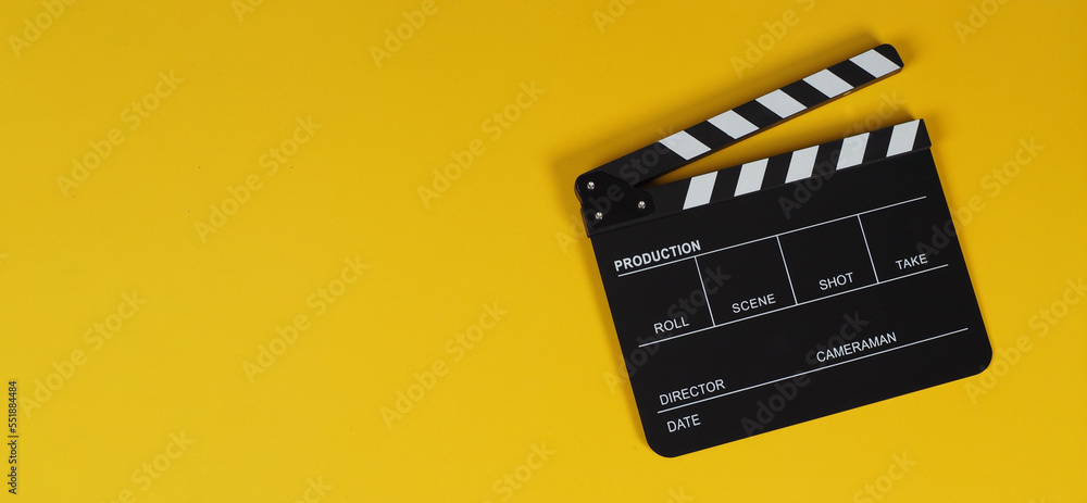 clapper board or movie slate on yellow background.