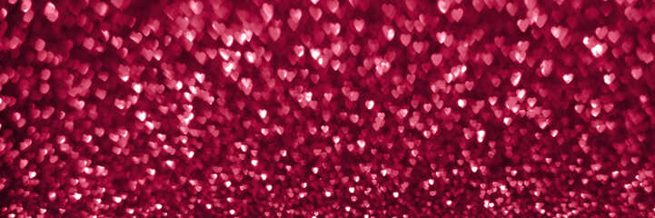 Trendy viva magenta, pink red hearts, sparkling glitter bokeh panoramic background banner, valentines day abstract defocused texture header. Color of the year 2023