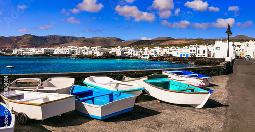 Lanzarote scenic places. Charming Punta Mujeres traditional fishing village with colorful boats and white houses. popular for natural swim pools. Canary islands travel