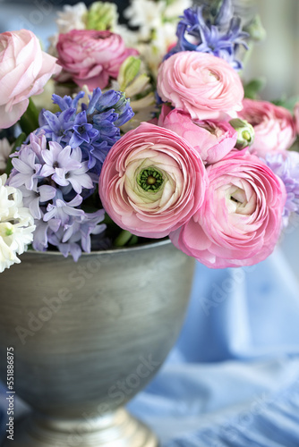 Beautiful bouquet of spring flowers in a vase on the table. Lovely bunch of flowers .

