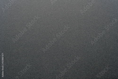 Rough black plastic background and texture. Black plastic material, closeup