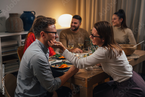 Husband and wife enjoy dinner time with friends