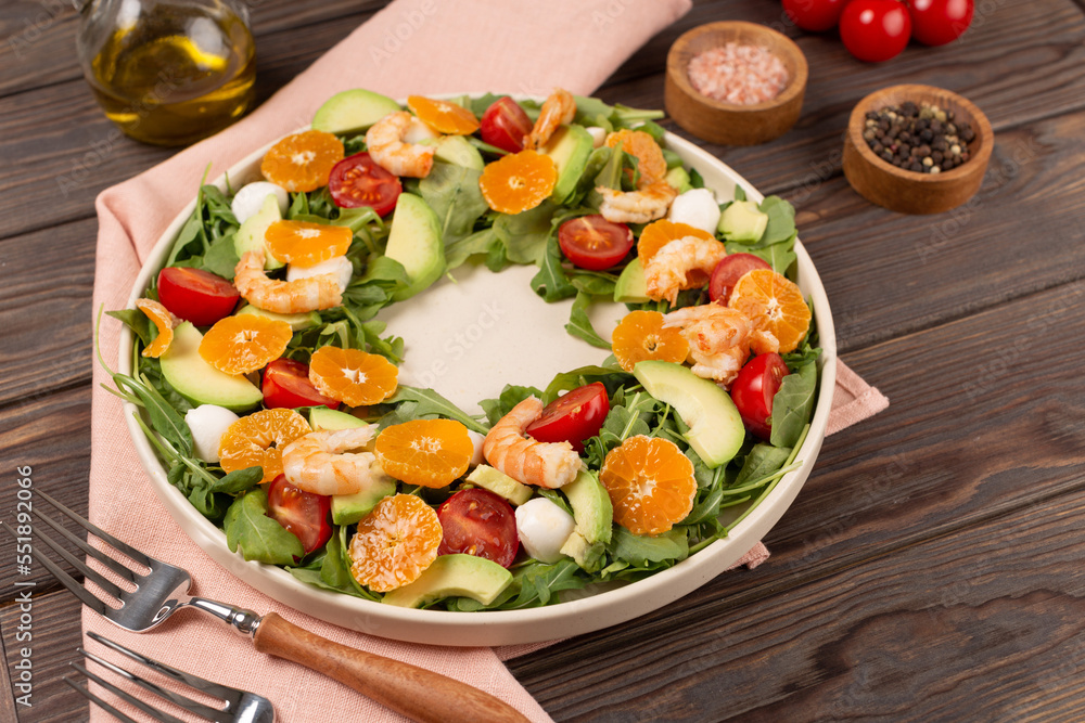 Salad with arugula, shrimp, tangerines, avocado, mozzarella and cherry tomatoes, open space