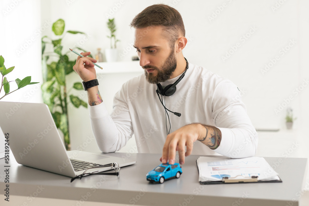 Car insurance online concept : A man holds a smartphone with checklist, toy car, Pen on table and use laptop check online case of accident. Car insurance online concept : A man holds a smartphone with checklist, toy car, Pen on table and use laptop check online case of accident.