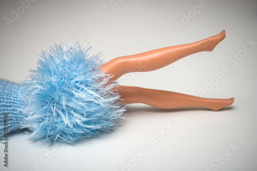 Tela Closeup of mannequin doll legs with a blue woolen dress on white background