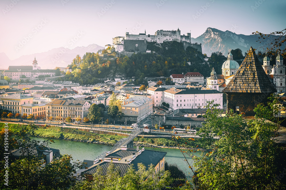 Incredible view of the historic city of Salzburg with famous Hohensalzburg Fortress and fortification tower in beautiful at sunny day in Autumn. Popular travel and historical center of Austria.