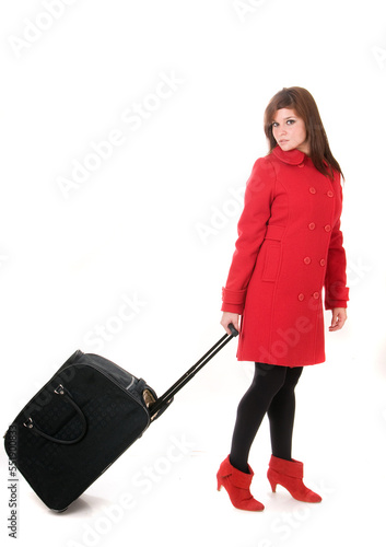 Attractive woman in red coat with bag or suitcase on white background