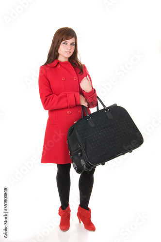 Attractive woman in red coat with bag or suitcase on white background photo