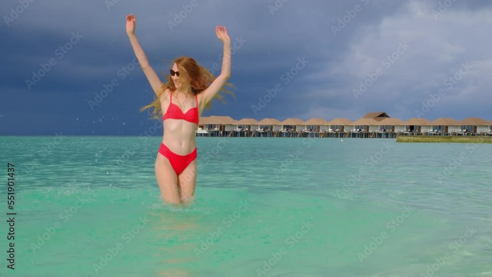 Woman in a bikini with a cocktail is laying. Happy female on Maldives. Woman in a bikini with a cocktail is laying. Happy female on Maldives.