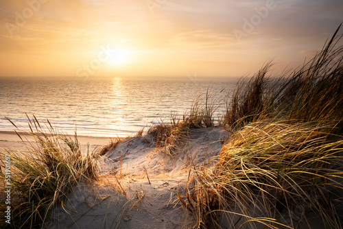 warm golden sunset over north sea beach