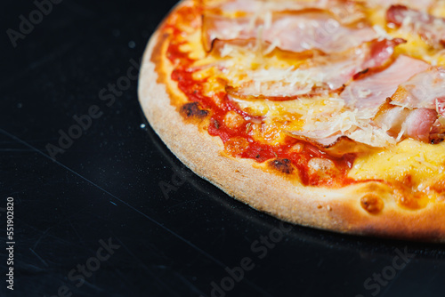 Delicious freshly baked pizza with tomato sauce and meat and cheese filling.