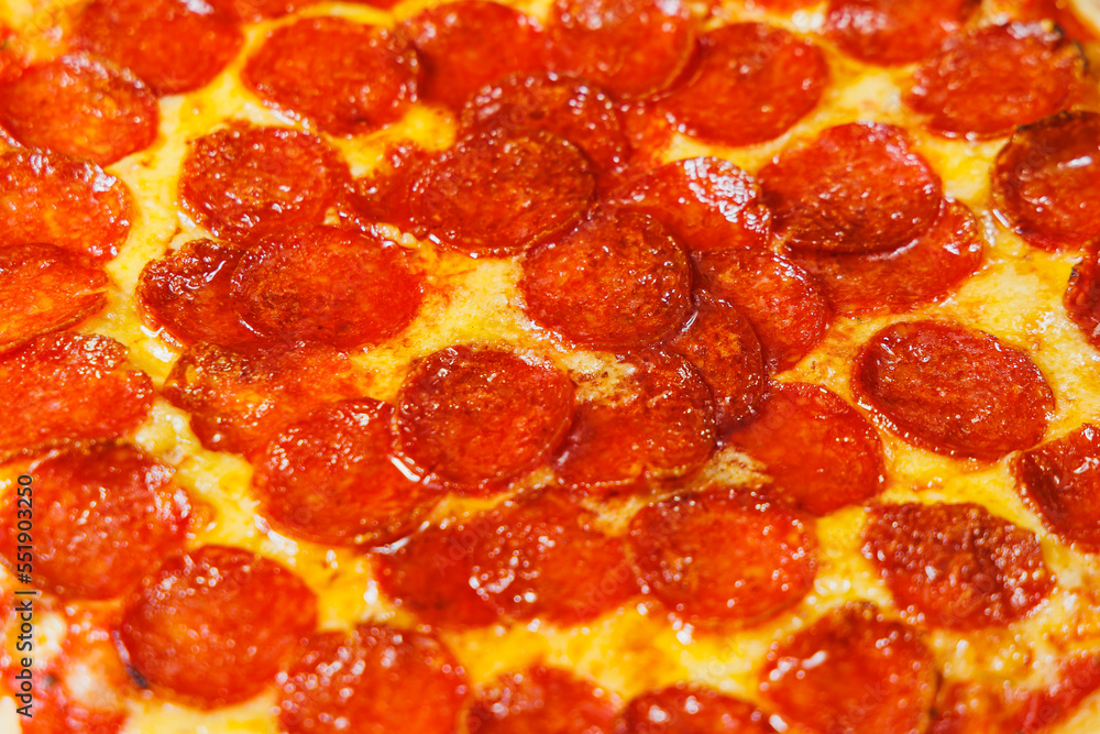 Sliced pizza with sausage, tomato sauce, mozzarella, onion and dough rim, topped with cream cheese on a black background Sliced pizza with sausage, tomato sauce, mozzarella, onion and dough rim, topped with cream cheese on a black background