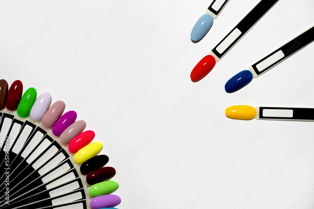 Naklejka premium Nail polish samples of different bright colors on a white background. Colorful manicure samples with nail polish. Top view of the gel polish palette for nail art. place for text