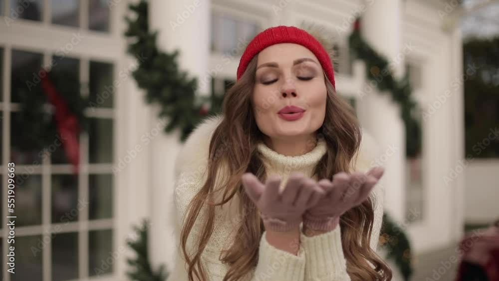 Beautiful woman sending air kisses at Christmas. Beautiful woman sending air kisses at Christmas.