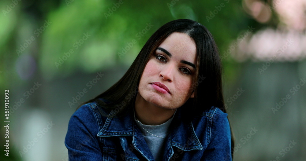 Millennial woman posing at camera outside with different emotions and faces Millennial woman posing at camera outside with different emotions and faces