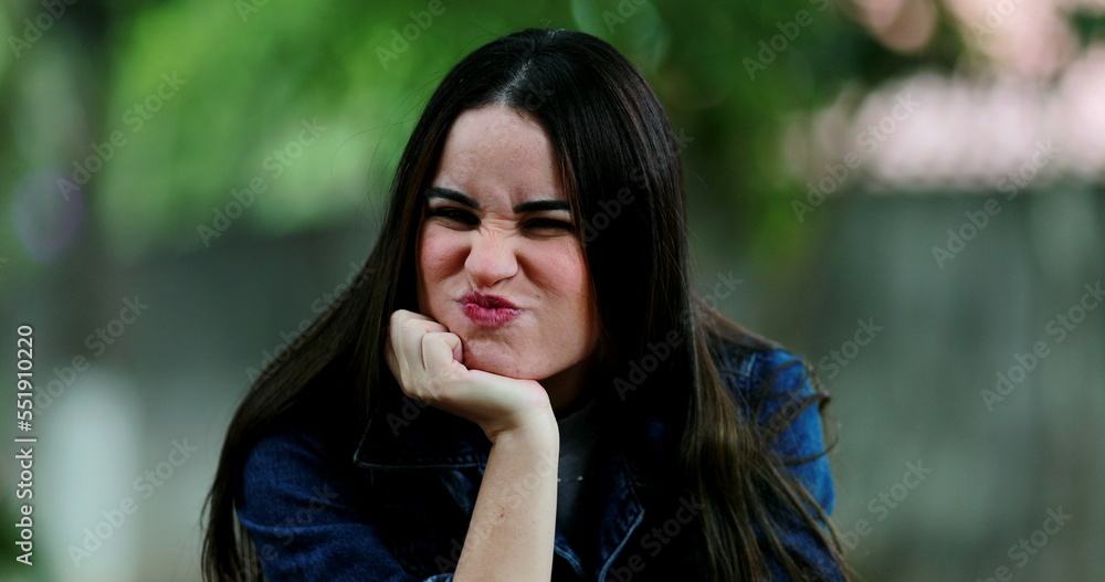 Millennial woman posing at camera outside with different emotions and faces Millennial woman posing at camera outside with different emotions and faces